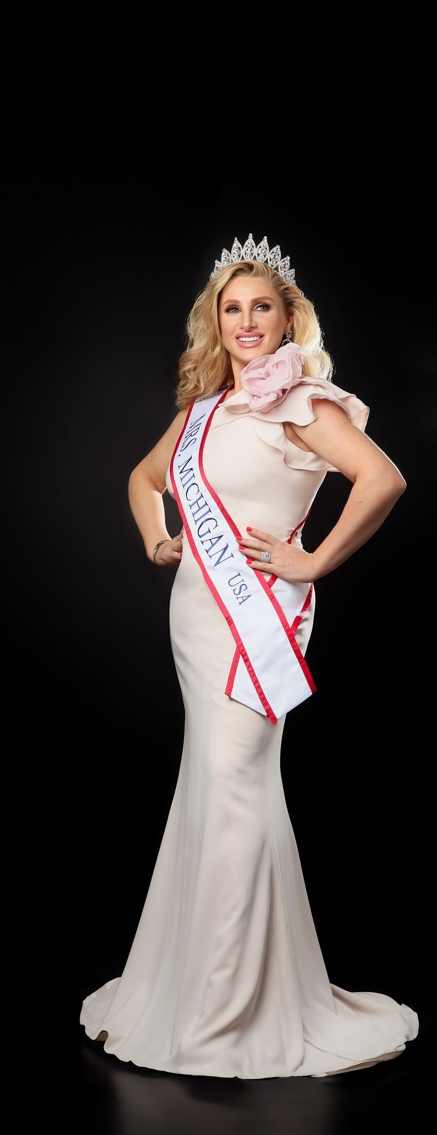 A pageant portrait — tiara, sash and ivory gown on black