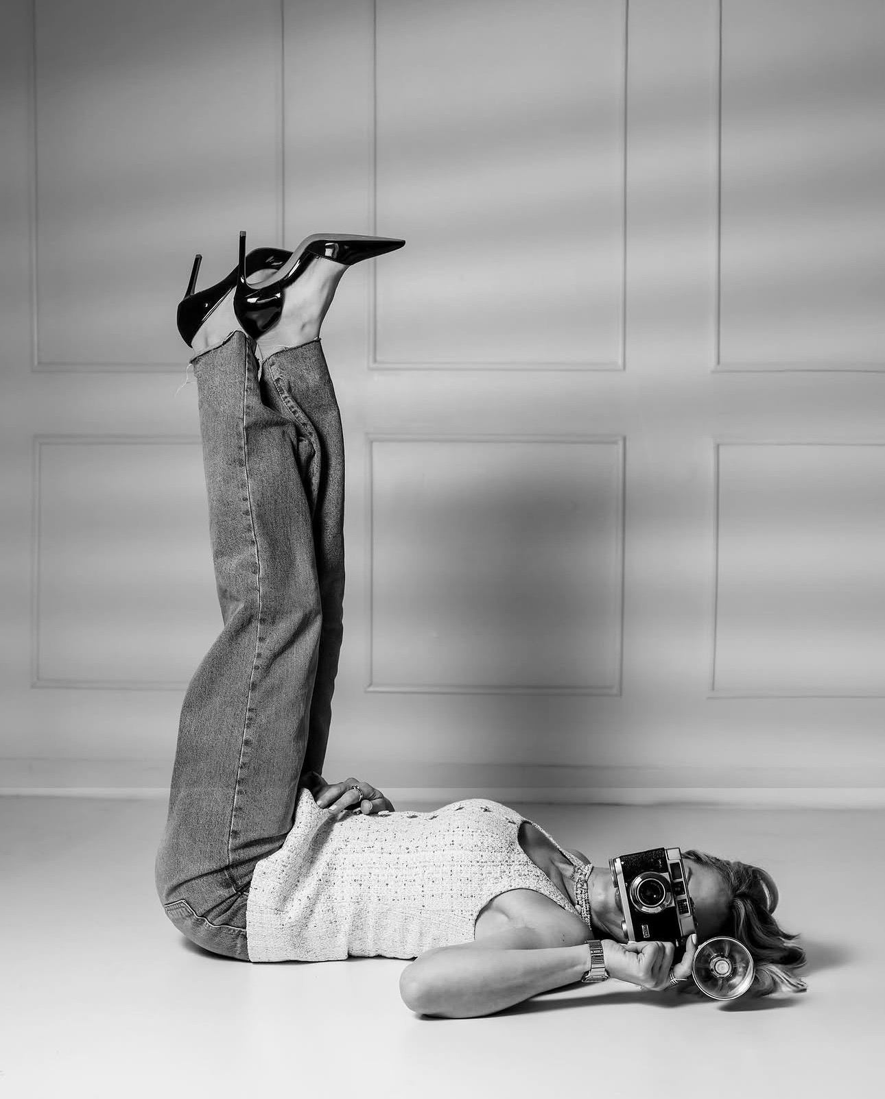 Black and white — a figure reclined with a camera