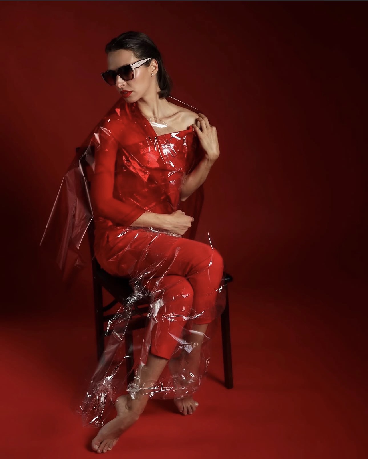 Red on red — seated in translucent tailoring