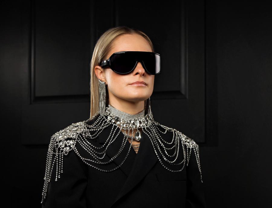 Shield sunglasses and a crystal-chain shoulder piece on black