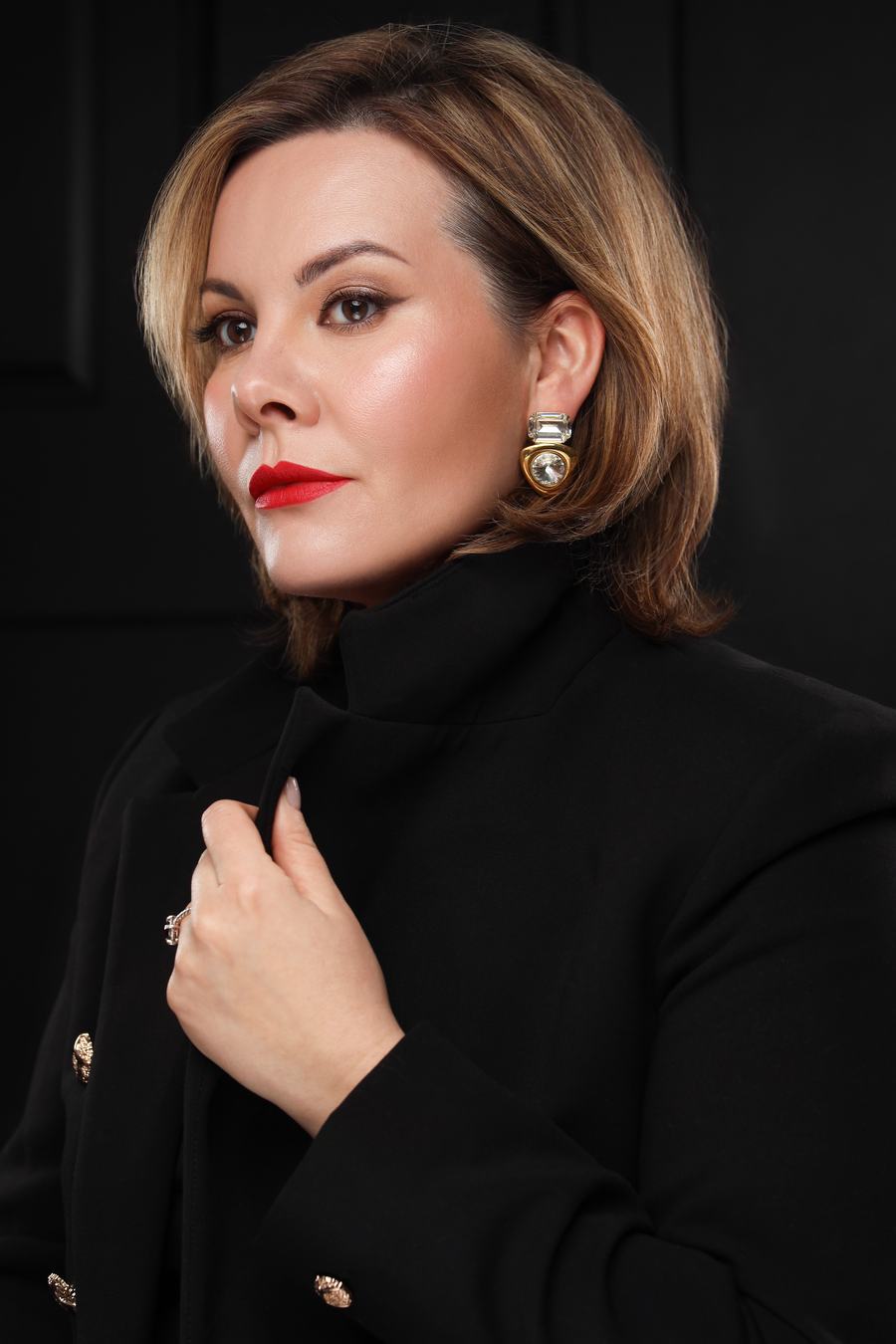 A sleek bob, red lips and a high black collar against black